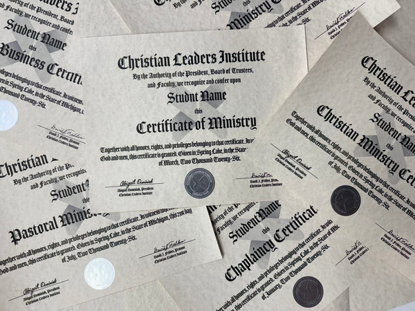 A close-up of several printed certificates laid out on a light surface, including documents from Christian Leaders Institute and titles such as Certificate of Ministry, Pastoral Ministry, and Chaplaincy Certificate. The papers are off-white with black text and a few dark round seals are visible.