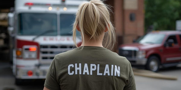 Chaplain standing near a fire truck and emergency response vehicles