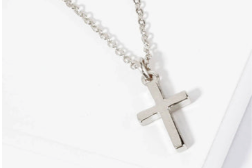 Small metal dainty cross pendant necklace on a thin chain