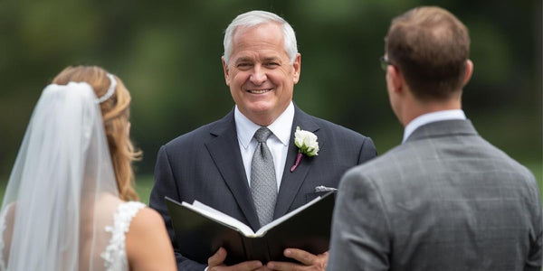 Wedding officiant leading a ceremony with bride and groom outdoors