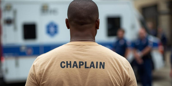 Fire and EMS chaplain wearing a shirt labeled “Chaplain” near emergency responders