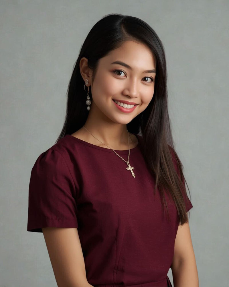 Woman wearing a burgundy top with a gray background